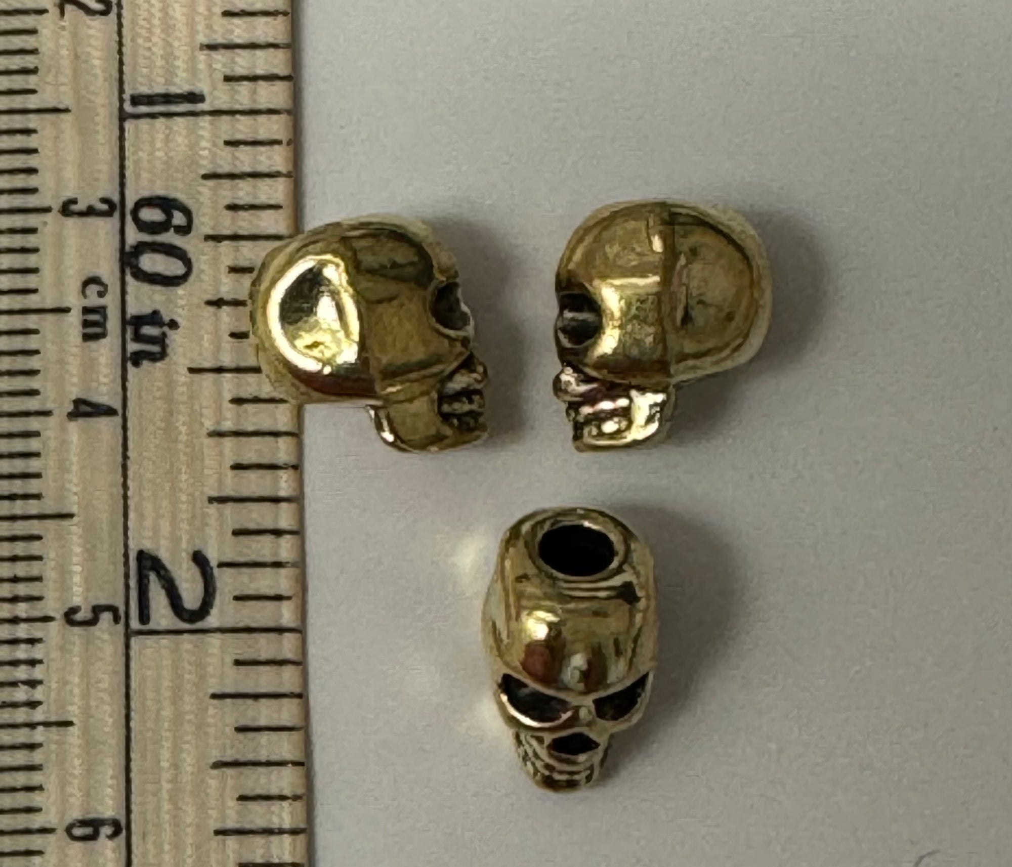 Goldtone Skull with black eyes embellishment - The Flying Needles
